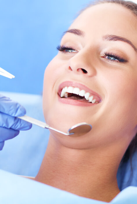 Woman having teeth examined at dentists