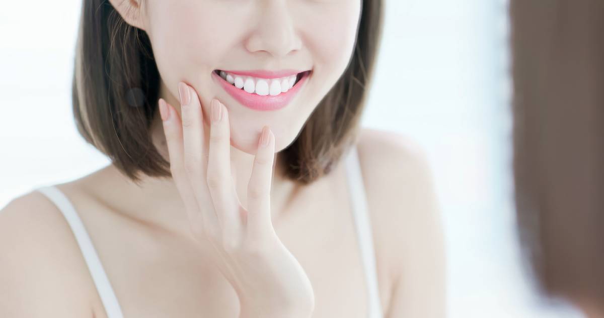 Woman smiling after having teeth stains removed.