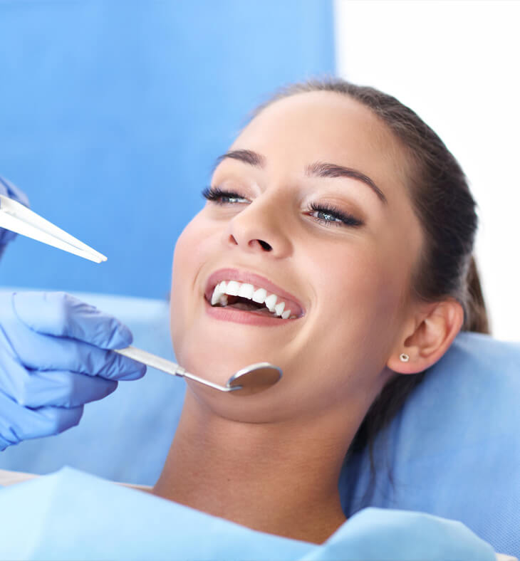 Woman having teeth examined at dentists