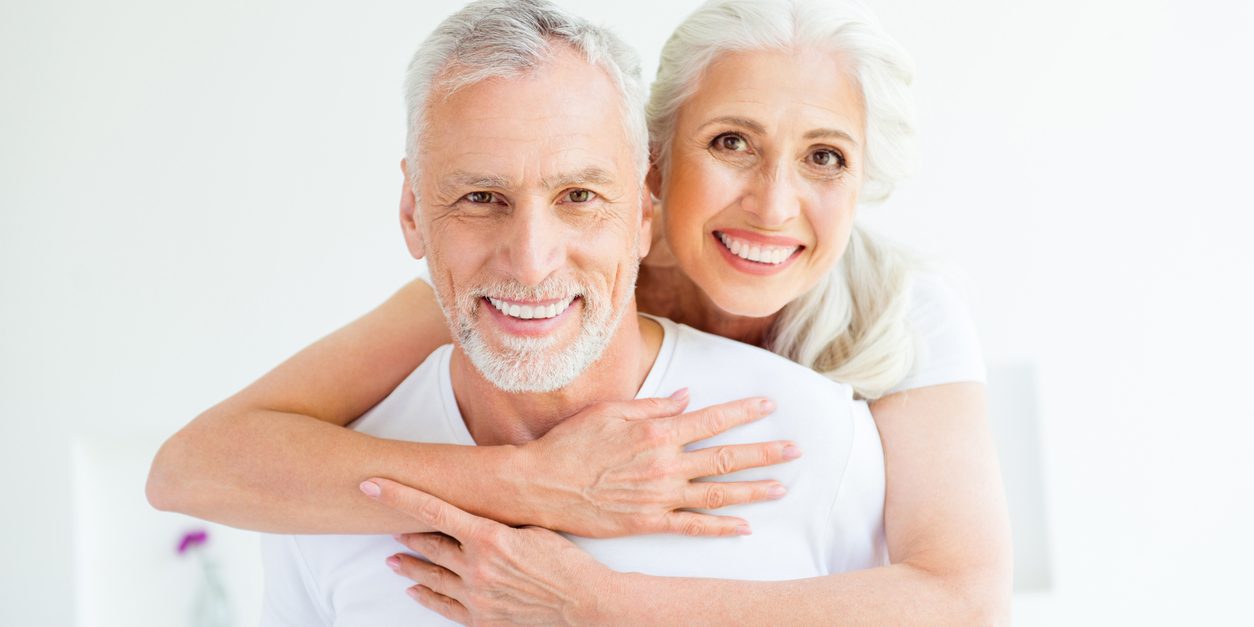 Woman hugging a man while both smile.